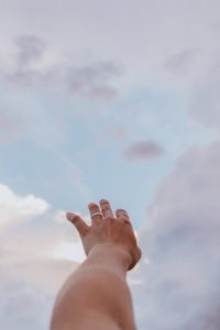 A hand is raised to heaven.