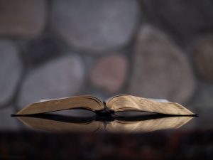 An open bible lies on a table.