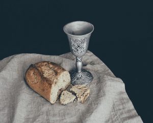 Blessed bread and wine sit on a table for this week.