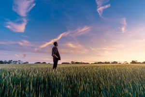 A guy standing in a field.