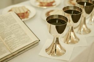 A Bible lies open on a table next to a biscuit and grape juice for Tuesday's communion service.